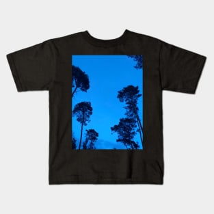 The trees are are watching us from a clear blue night sky Kids T-Shirt